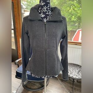 Lululemon jacket with a zip away hood, pockets, and a cute peplum in the back.